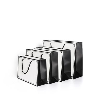 Покупки упаковывая прокатанный Tote бумаги искусства C1S кладут изготовленный на заказ логотип в мешки